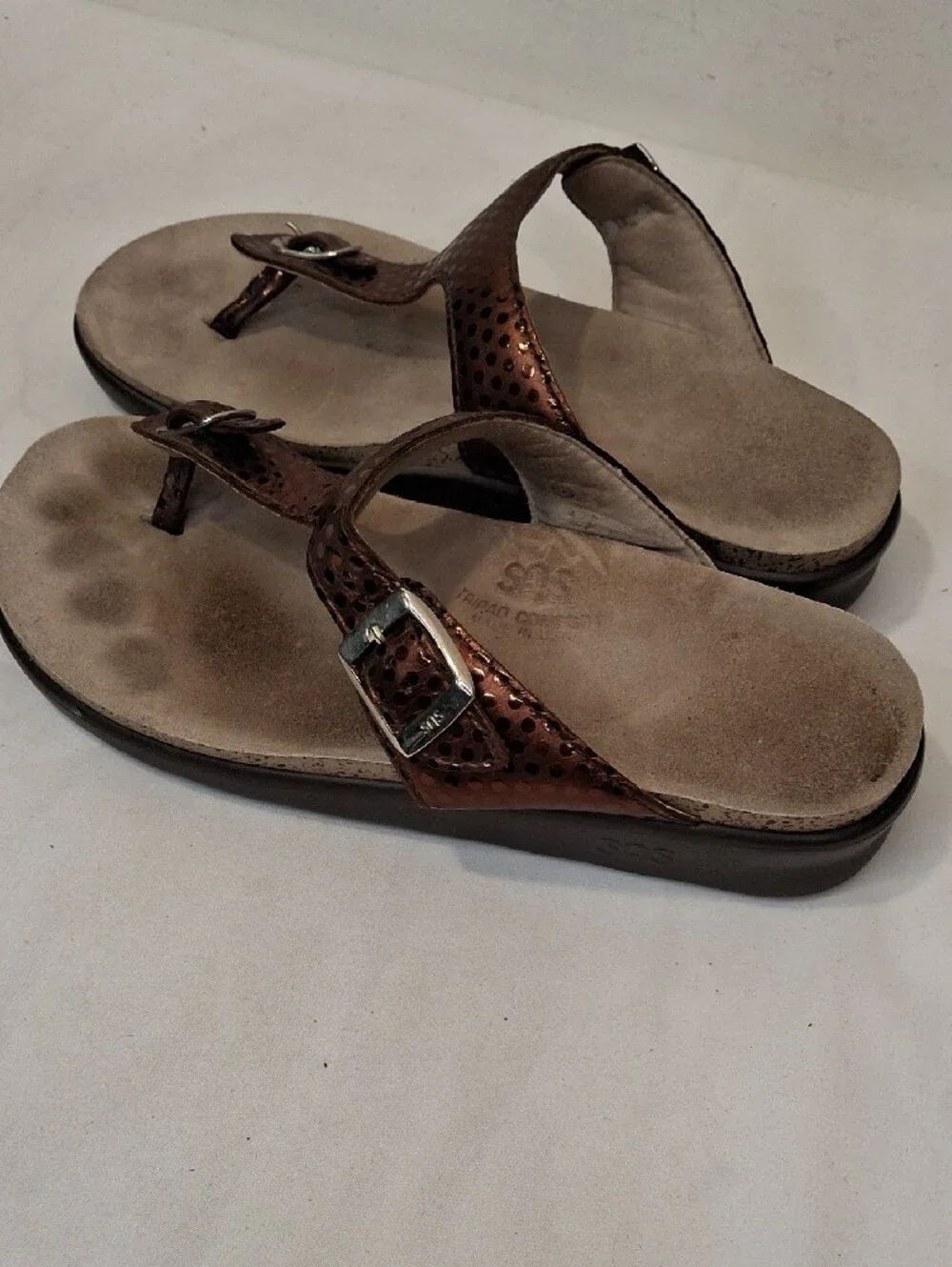SAS Sanibel Metallic Bronze Gold Thong T Strap Sandals with Gold Buckle Detail.